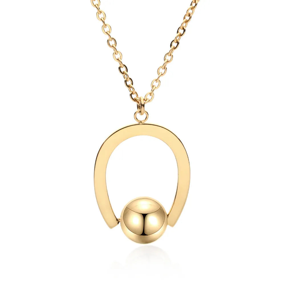 Gold electroplated stainless steel necklace with geometric pendant on an adjustable chain.