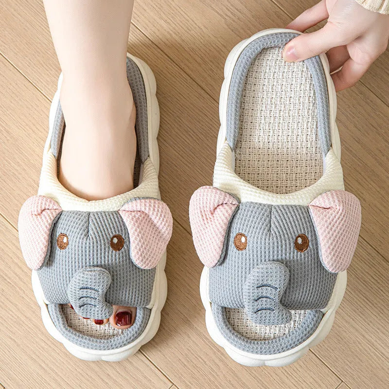 Elephant grey open-toe linen slippers for couples on a plain background, showing sewn sole detail.