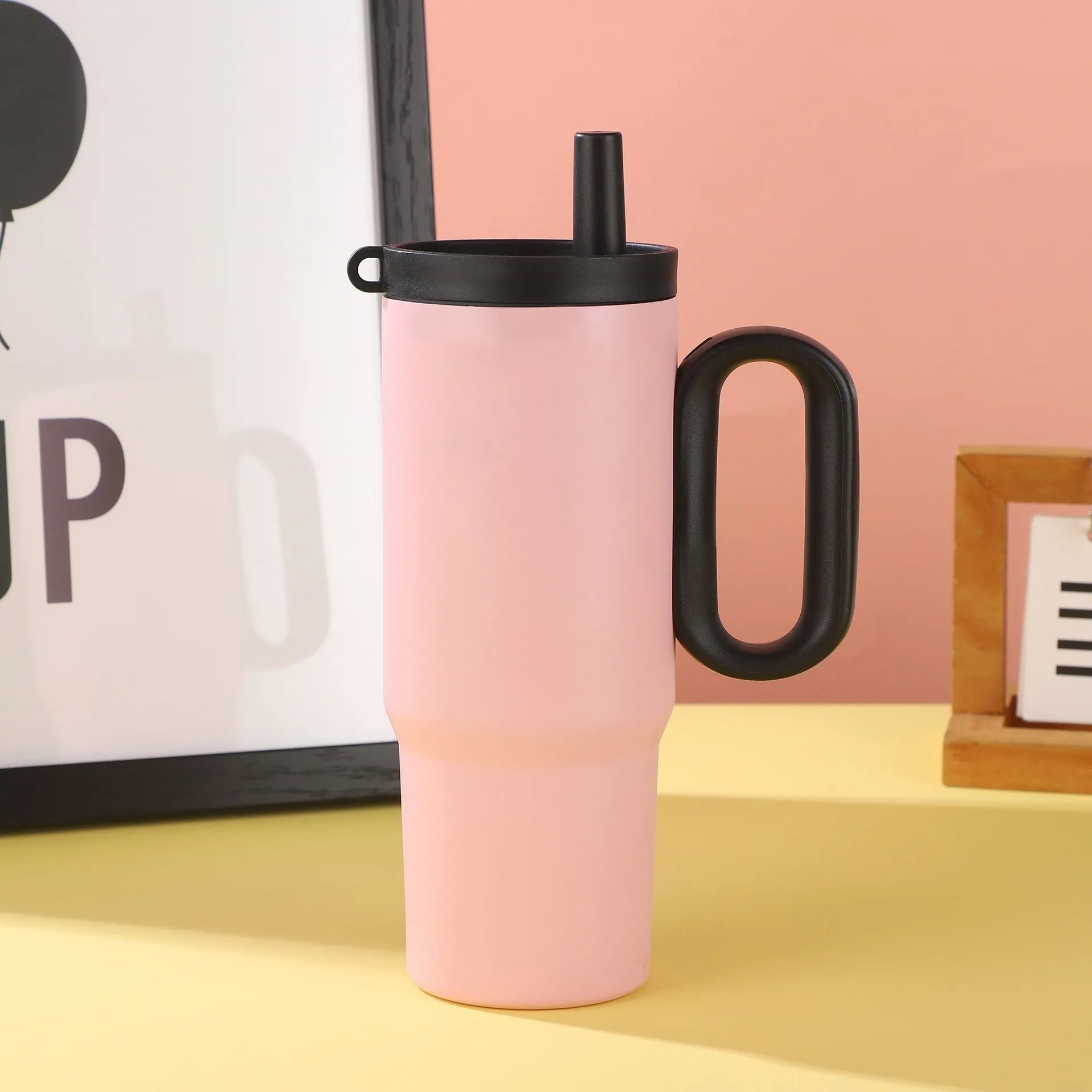 Insulated plastic straw cup with carry handle in five colour options showing 700ml capacity