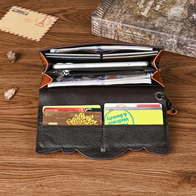 Retro brown embossed floral pattern tri-fold women's wallet made from genuine cowhide, shown open.