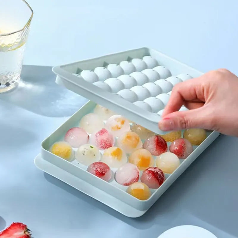 Blue silicone ice cube tray with lid showing 33 round holes for large ice cubes