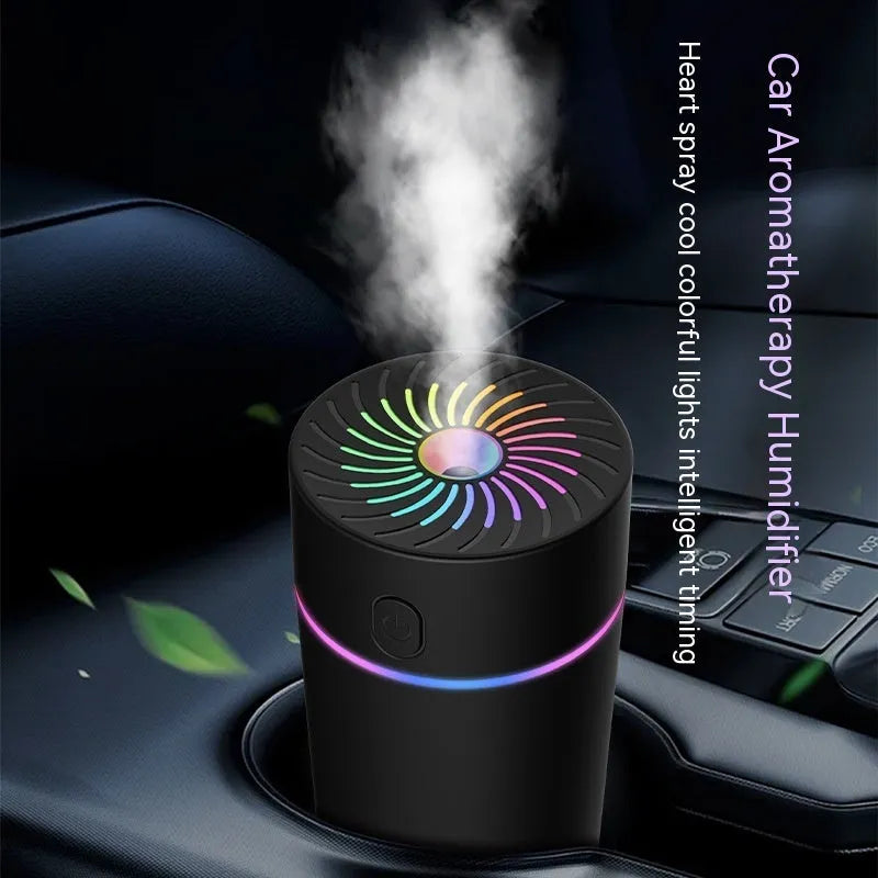 Black and white USB car mini humidifier with aromatherapy function on a car dashboard.