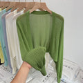 Thin polyester linen blouse with hollow out pattern and long lantern sleeves in apricot colour.
