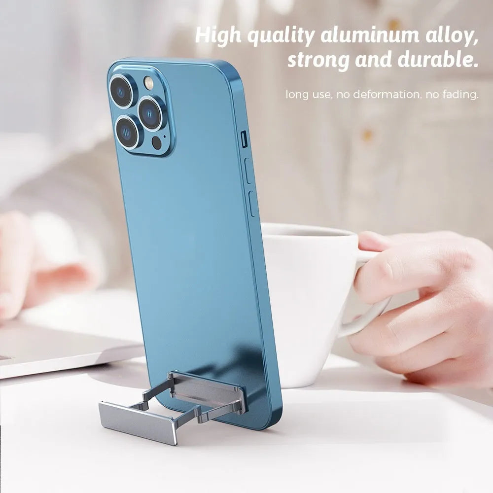 Aluminium alloy foldable mobile phone bracket with back sticker in silver, light gray, and black on a white background