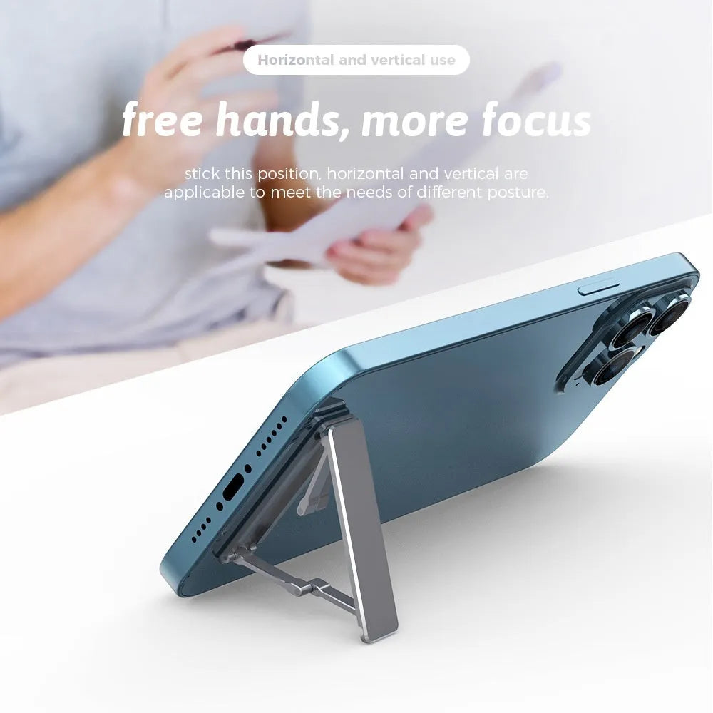 Aluminium alloy foldable mobile phone bracket with back sticker in silver, light gray, and black on a white background