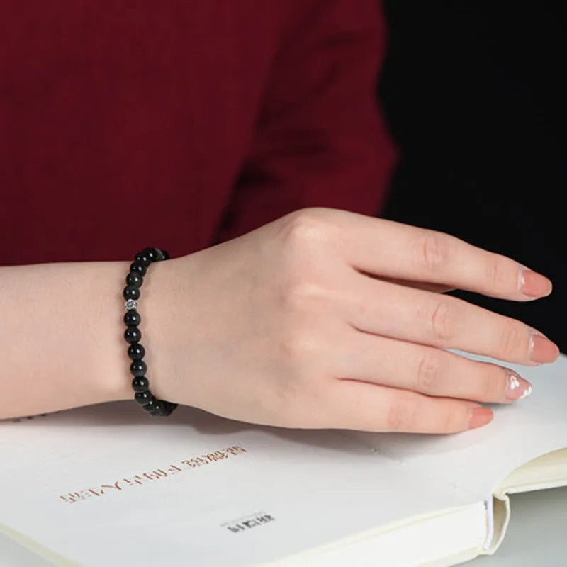 Natural obsidian bracelet with S925 silver flower charm and dragon phoenix constellation design