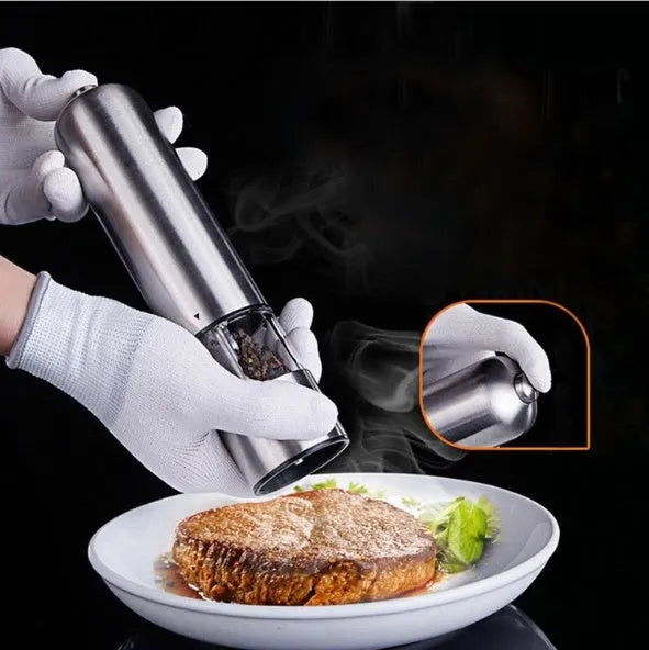 Stainless steel electric pepper grinder on a kitchen countertop