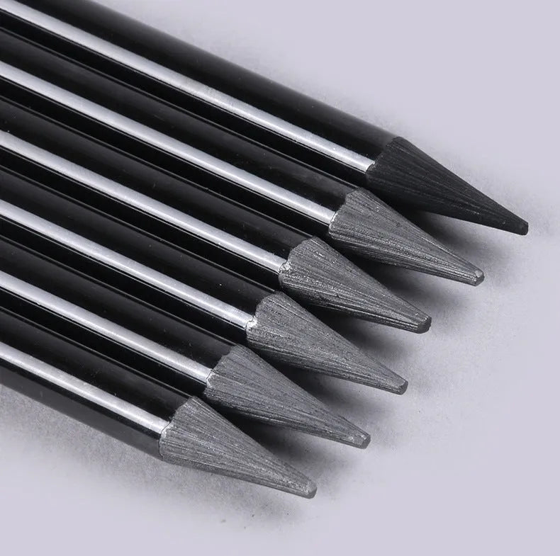 Set of graphite and carbonized wooden pencils on a suction card packaging.