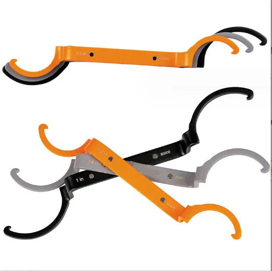 Orange, grey, and black magnetic suction wrenches laid out to show crescent, catheter locking, and standard spanner types.