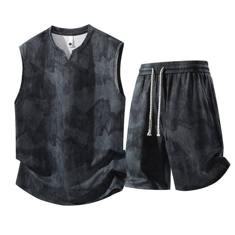 Plus-size man wearing black blue sleeveless vest suit with matching shorts in casual setting