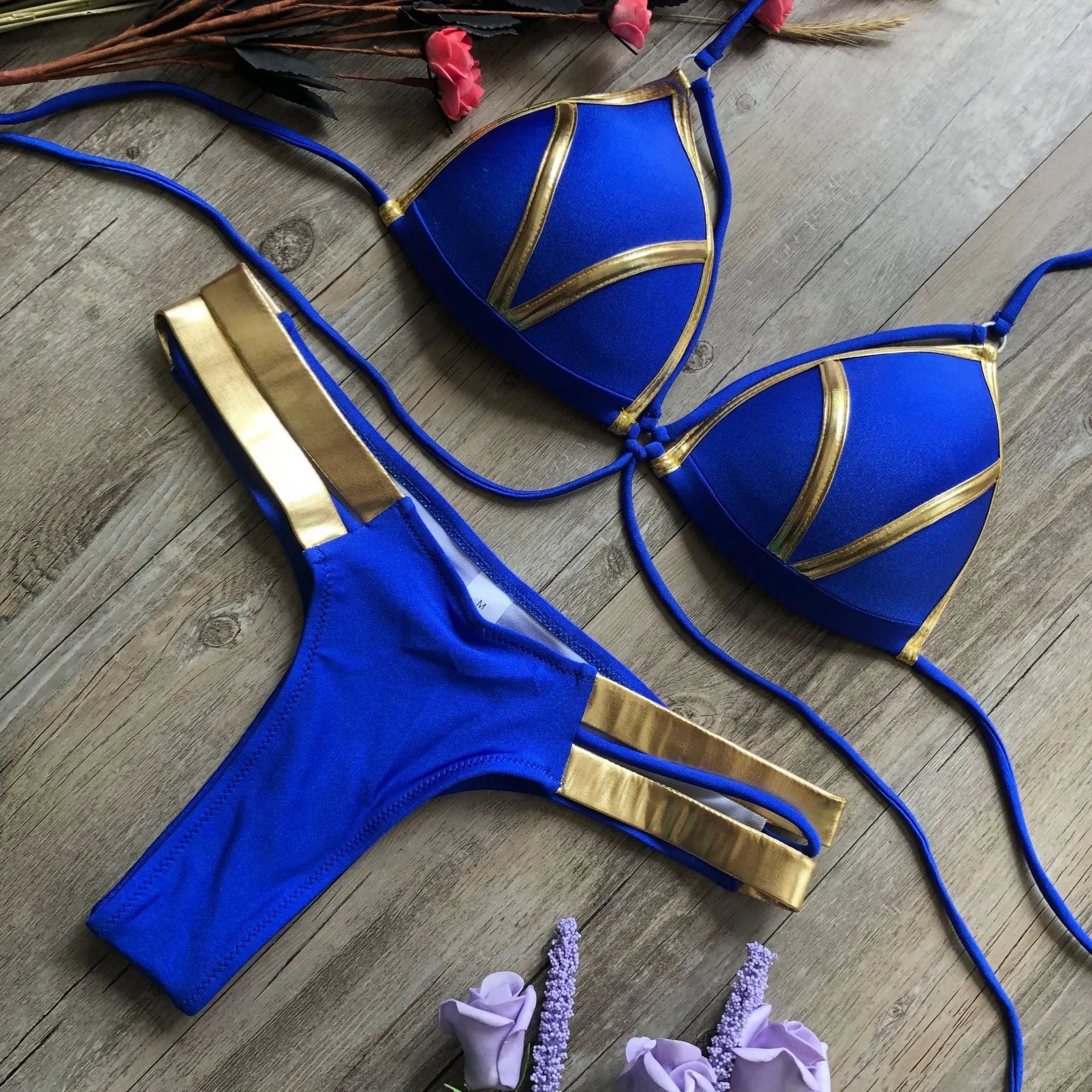 Women's bronzing bikini top and bottom set on a mannequin, showing adjustable straps.