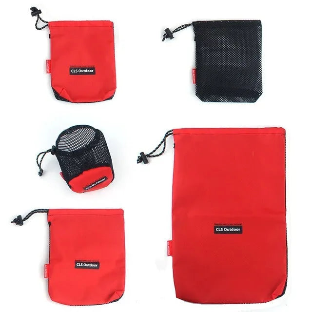 Set of five red outdoor travel storage bags with zippers and mesh panels on a plain background