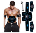 USB rechargeable EMS abdominal muscle stimulator with belt and arm pads on a home gym floor