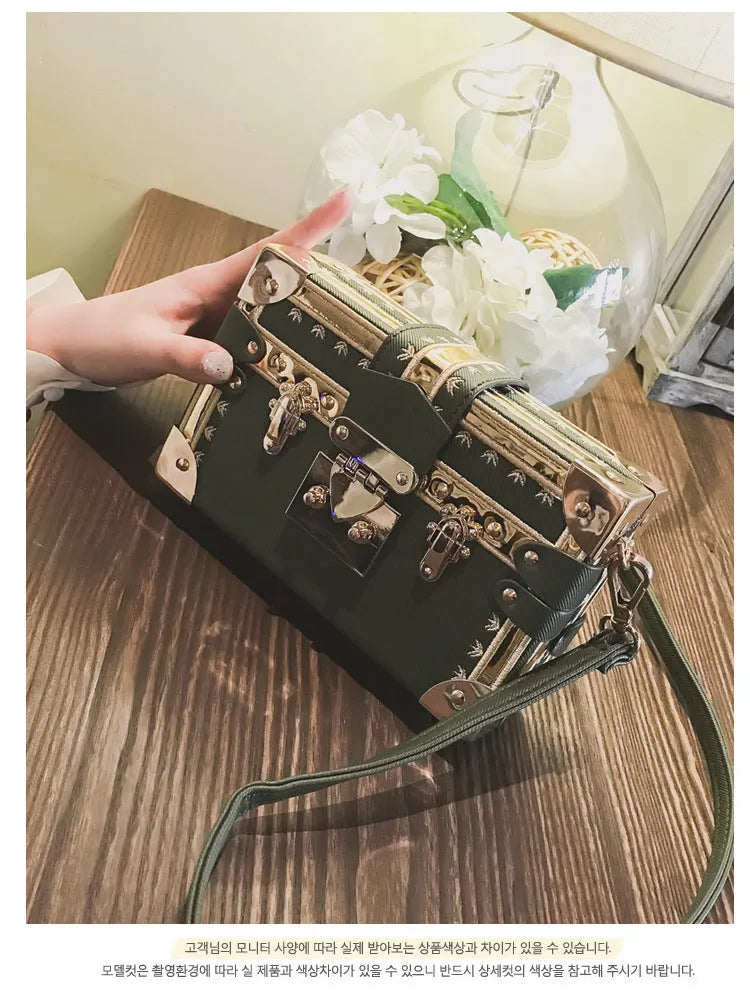 Black hard shell women's shoulder bag with a flap and crossbody strap