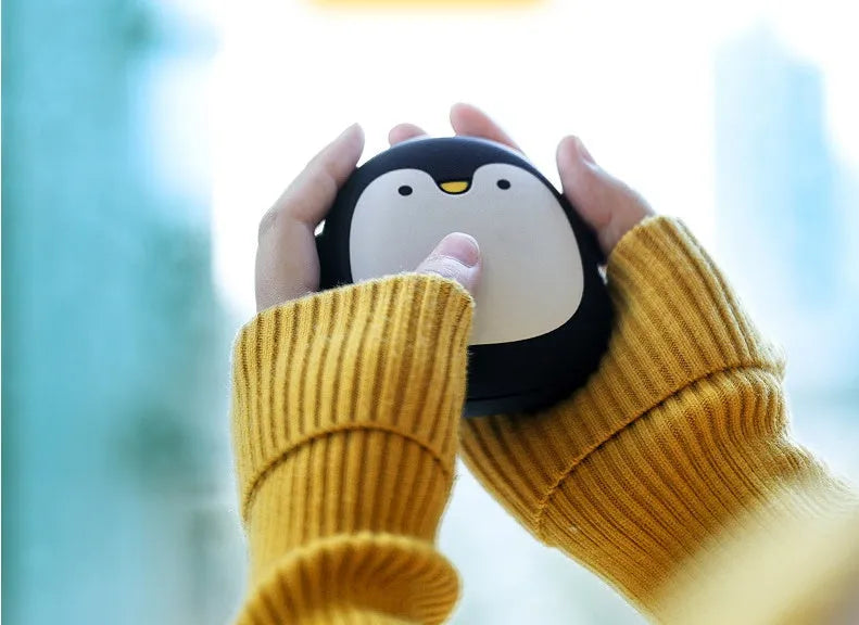 Cartoon penguin and polar bear USB rechargeable electric hand warmers showing dual-sided heating design
