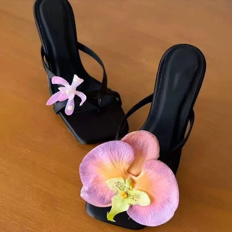 Women's handmade asymmetric flower design sandals with a high heel in calf leather.