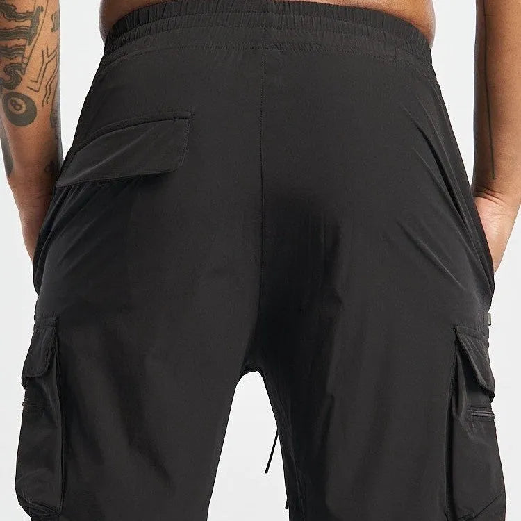 Man's black quick-drying sports shorts with elastic waistband for fitness and running activities.