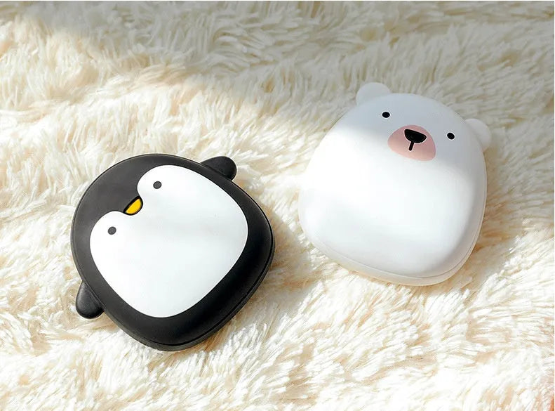 Cartoon penguin and polar bear USB rechargeable electric hand warmers showing dual-sided heating design