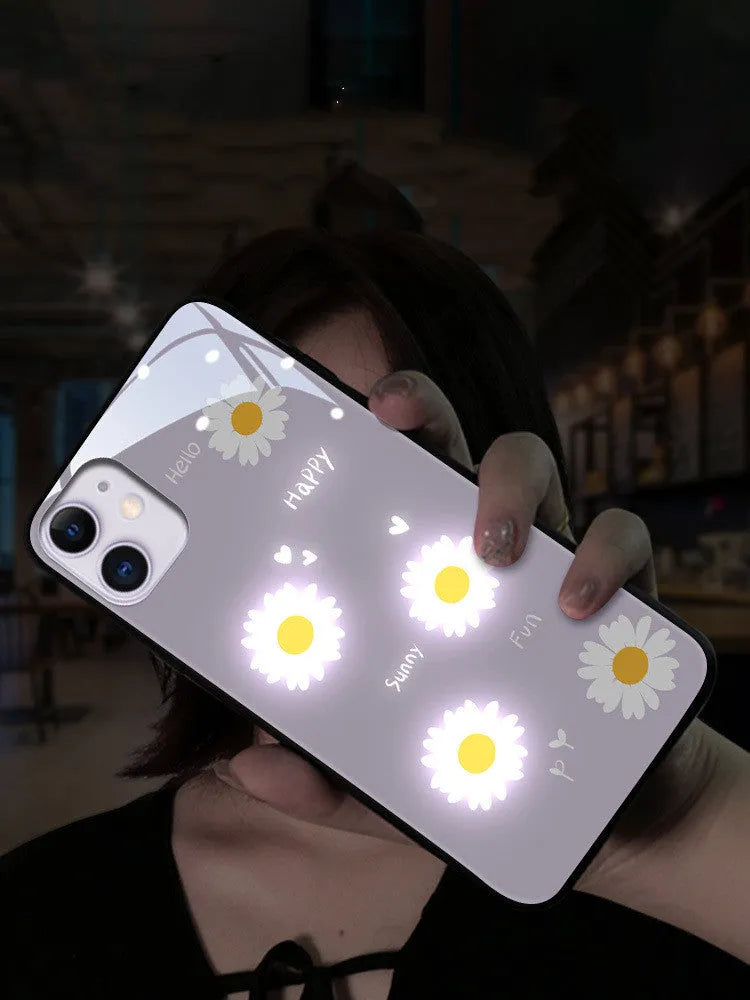 White iPhone case with painted purple daisies and voice-activated colour lights on the back.