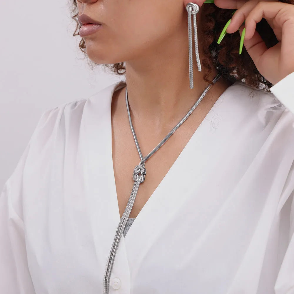 Gold-plated titanium steel necklace with knotted tassel pendant and matching earrings