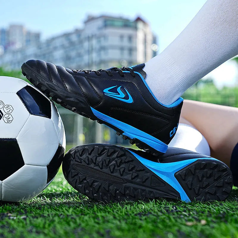 Low-top outdoor soccer shoes in a broken nail colour pattern with a rubber sole and lace-up front.