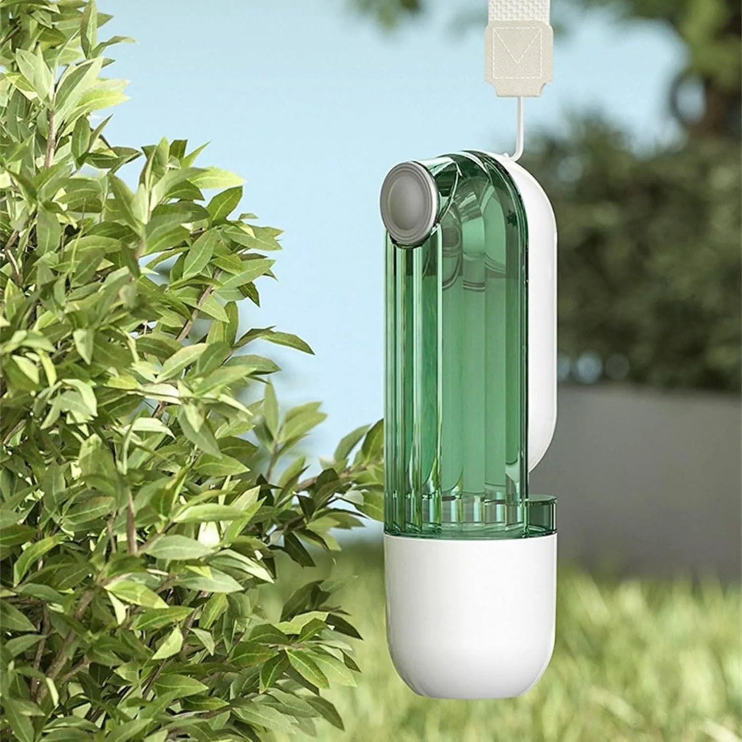 Beige collapsible dog water bottle with food container at base, showing press dispenser and tray.