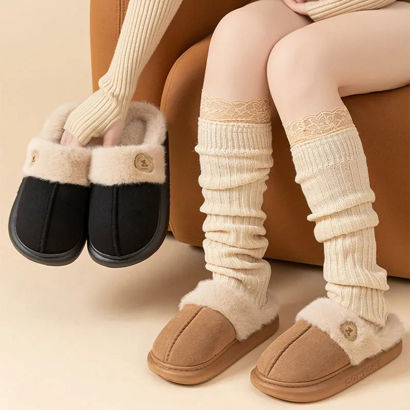 Pair of thick-soled fleece slippers in various colours on a plain background
