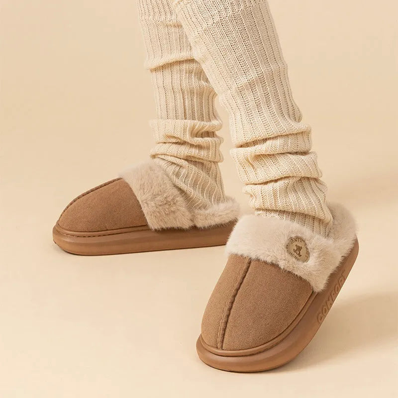 Pair of thick-soled fleece slippers in various colours on a plain background