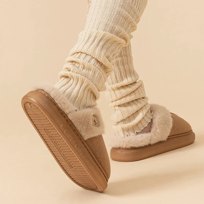 Pair of thick-soled fleece slippers in various colours on a plain background