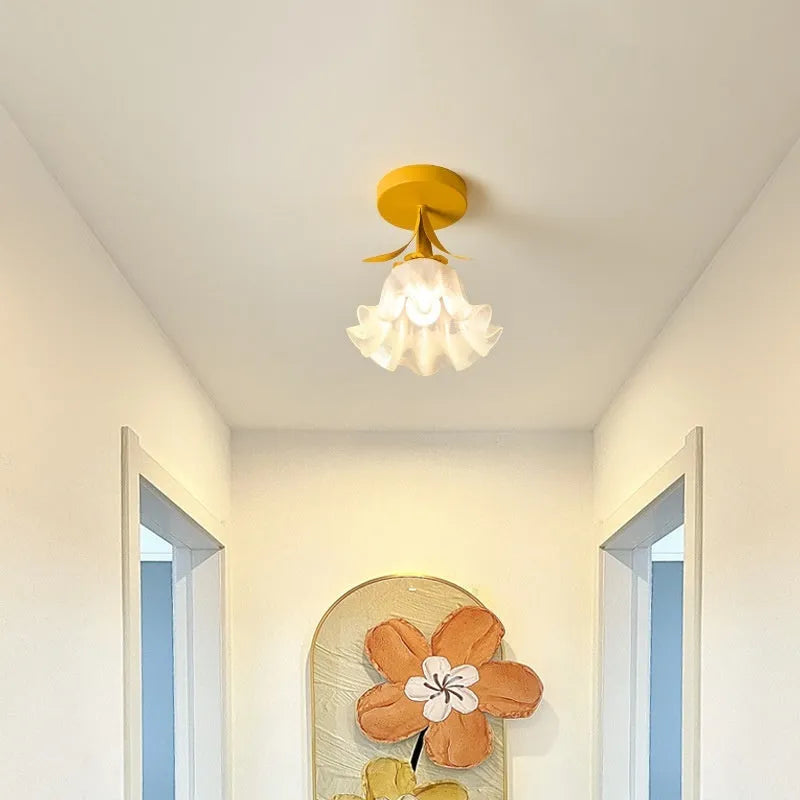 Cream coloured Linglan flower modern corridor wall light fixture on display.