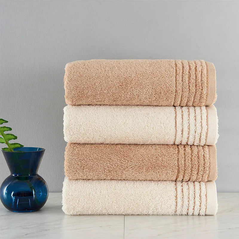 Cotton towel set in beige and brown showing three different sizes including large bath towel