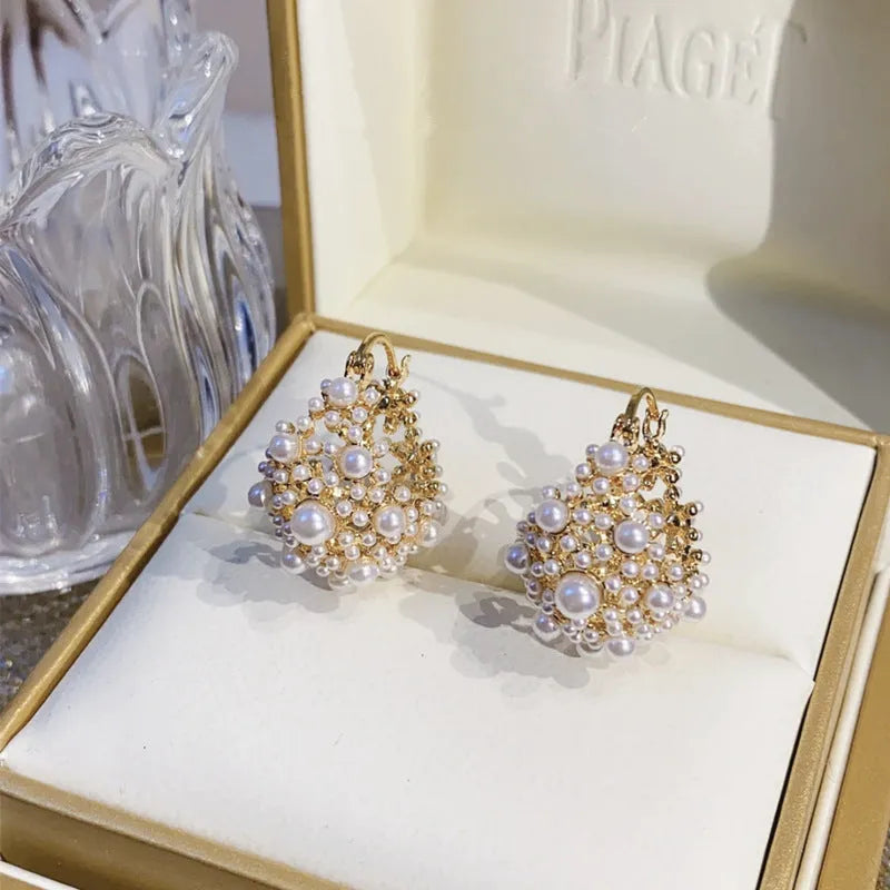 Gold floral basket earrings with pearl inlay detail on rice-shaped beads