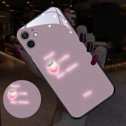 White iPhone case with painted purple daisies and voice-activated colour lights on the back.