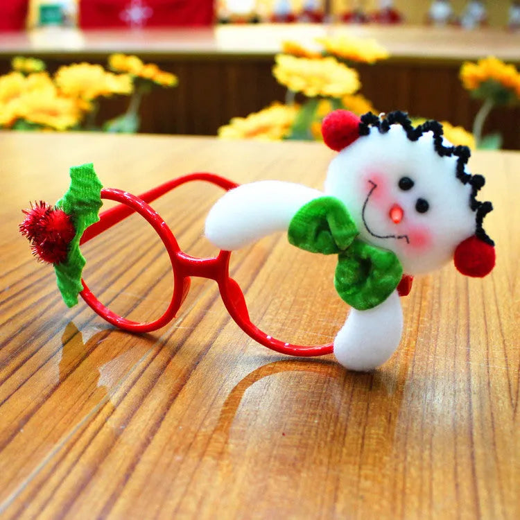 Set of four Christmas novelty glasses: Santa, Snowman, antlers, and rabbit ears designs.