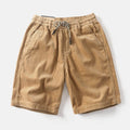 Men's retro American-style cargo shorts in straight-leg cut with multiple pockets, shown in khaki colour