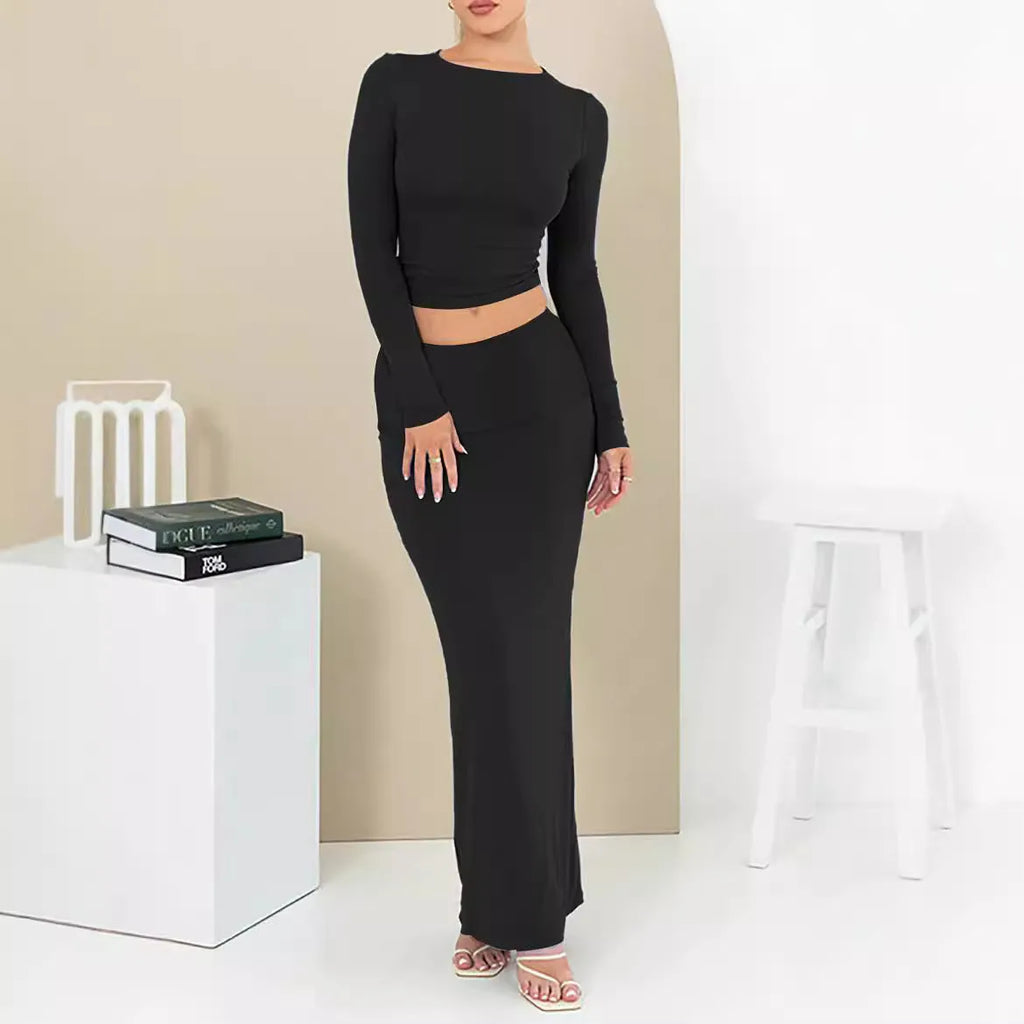 Women's autumn two-piece suit set in polyester, showing slim fit top with three-quarter sleeves and matching long skirt.