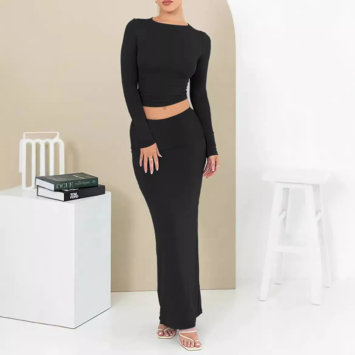 Women's autumn two-piece suit set in polyester, showing slim fit top with three-quarter sleeves and matching long skirt.