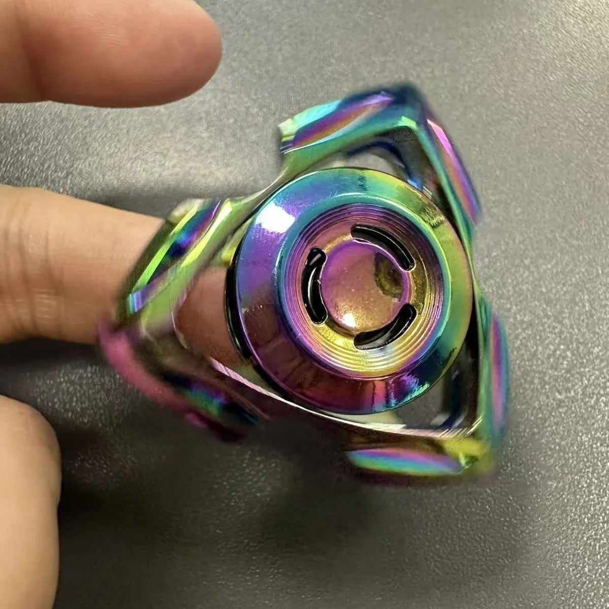 Silver and colourful alloy fingertip gyro decompression fidget toy.