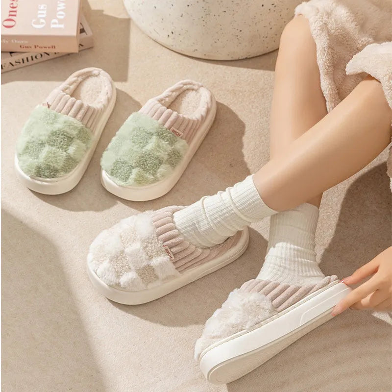 Plaid pattern women's plush slippers with round toe and flat heel on a coloured background.