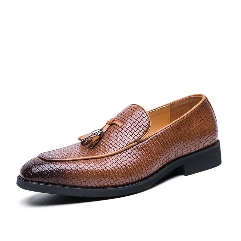 Men's black pointed slip-on business shoes with a tassel detail on the artificial PU leather upper.