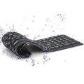 Black foldable silicone Bluetooth keyboard with 108 keys, unfolded, showing full key layout