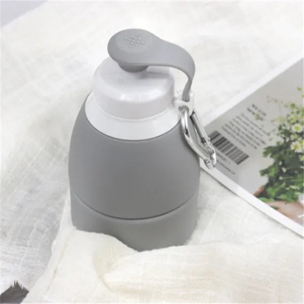 Blue silicone folding water bottle shown both fully expanded and folded to half its height