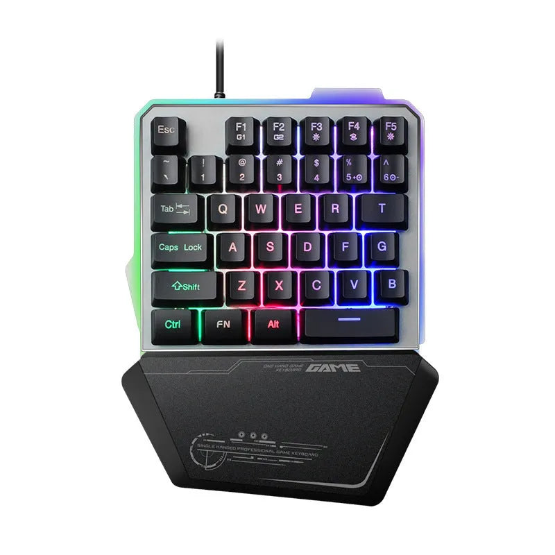 Black robotic one-handed mechanical keyboard with RGB backlit keys on a desk.