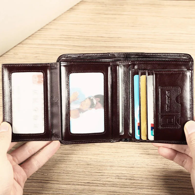 Men's black leather RFID blocking wallet open to show card slots, ID window, and coin pocket.