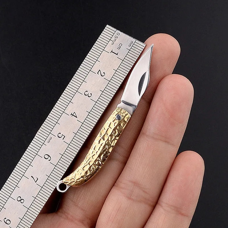 Brass mini folding knife keychain pendant with 3cm blade and 42mm shank on a key ring