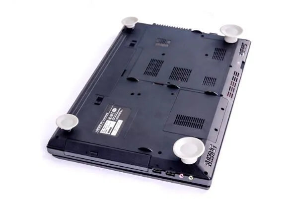 Set of four grey plastic laptop cooling pads, two large and two small, on a desk.
