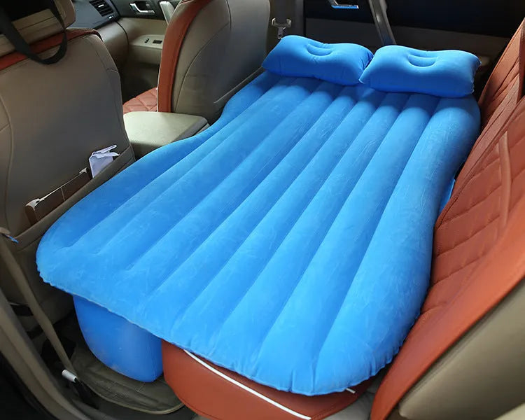 Universal inflatable car bed with flocked cloth, shown with two pillows and a pump.