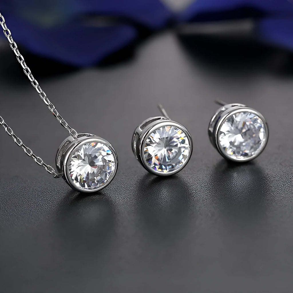 Bridal pendant and earring set with diamond-cut metal alloy finish on white background