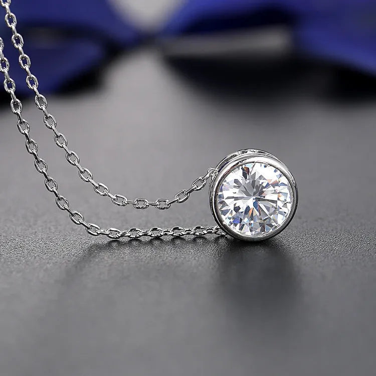 Bridal pendant and earring set with diamond-cut metal alloy finish on white background