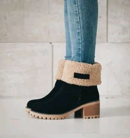 Women's suede mid-calf snow boots with thick flat sole in black, shown from the side.